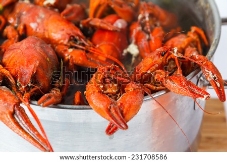 Boiled crayfish in pan on a wooden board, a traditional Russian dish