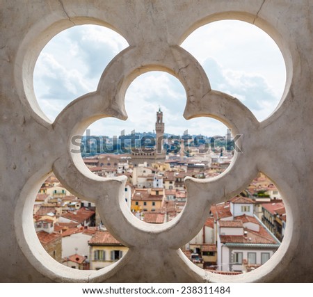 roofs, red tiles and narrow streets through the fence ornament bell tower in Florence, Italy
