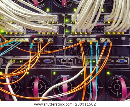 rack in the data center with working equipment with optical and UTP cables