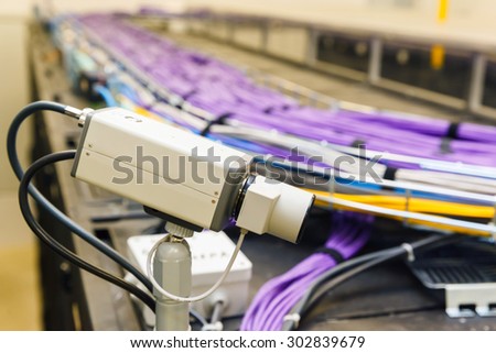 video monitoring and Large group of lilac utp Internet cables in rack data center