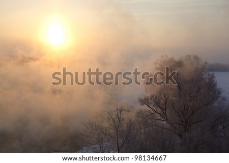 winter dawn and the mist on the background of blue sky over the water on the Moscow River