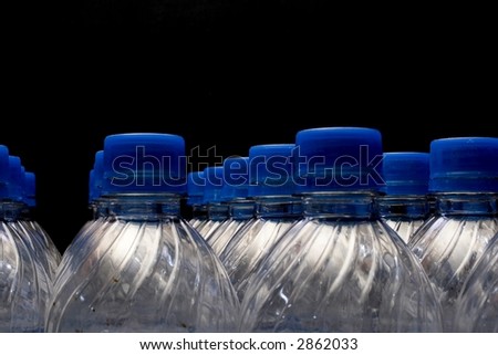 Plastic soda bottles over black.