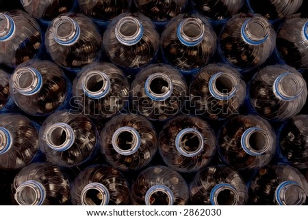 Plastic soda bottles over black.