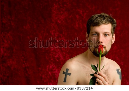 A young man with a single red rose.