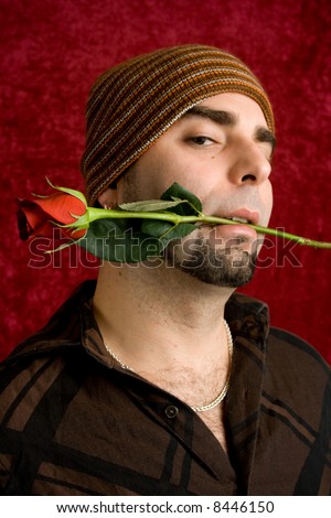 A young man with a single red rose.