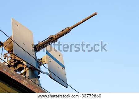 Large gun mounted on the deck of a WWII era US destroyer
