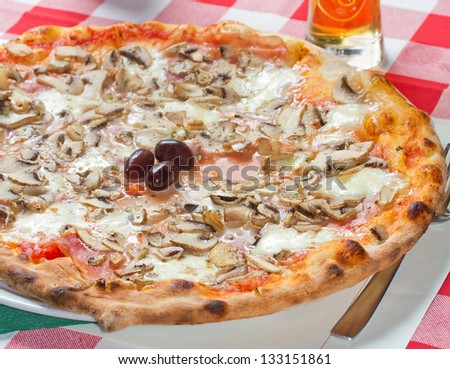 Tasty Pizza capriciosa on a restaurant table. See more