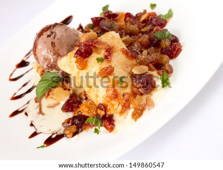 Pancake in white sauce, raisins and chocolate ice-cream