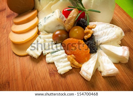 Variety of dairy products. Choice of cheese on wooden board.
