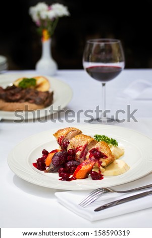 Seared duck breast with cherry sauce and wine. Fine dining