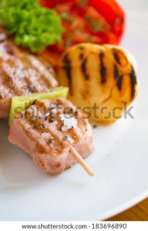 Delicious skewers served with some fresh vegetable and rice ball. Natural lighting