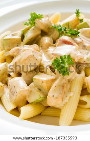 Close-up studio shot of Penne Chicken Alfredo in rich creamy sauce. Ideal for blog and recipe books