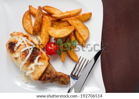 Wrapped drumstick and fries. Studio shot on white plate. See more food in my gallery