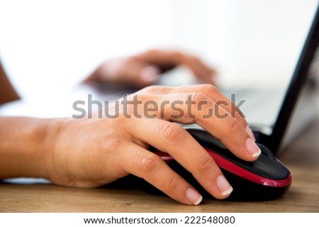 female hands clicking and touching on a laptop mouse and keys