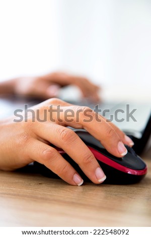 female hand touching mouse and keyboard to connect to the online world with lots of copy space. Horizontal version available.