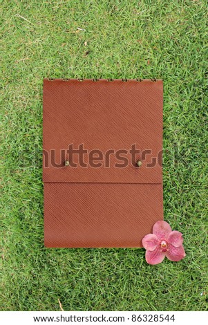 leather book cover on Grass