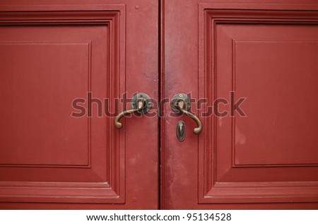 Door handles with an old double wood door red