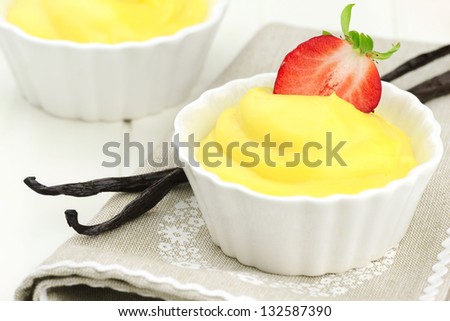 Delicious Italian dessert - vanilla cream with fresh strawberries and vanilla pods