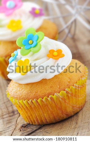 Delicious cupcakes decorated with colourful sugar paste flowers and buttercream