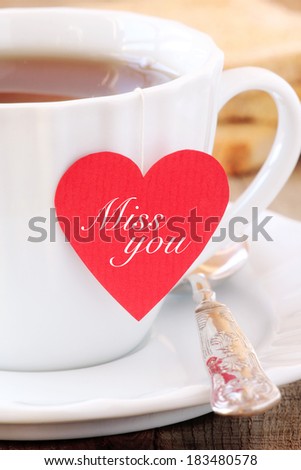 Cup of tea with red heart shaped teabag tag with a Miss you message