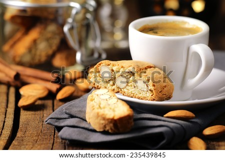 Good morning concept - breakfast frothy espresso coffee accompanied by delicious Italian almond cantuccini biscuits