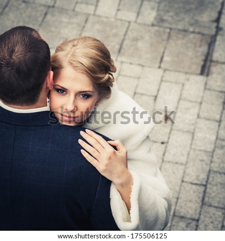 wedding. bride embraces the groom, and the background of the beautiful background tiles