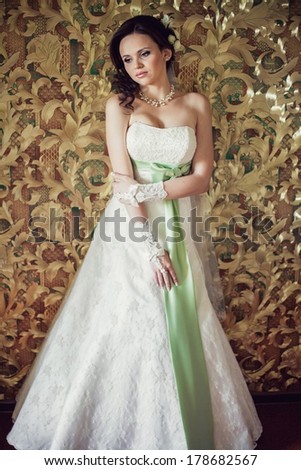 Bride on the unusual background in a beautiful wedding dress