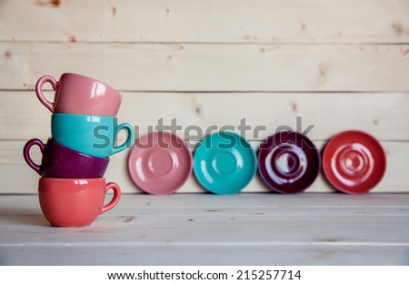 Bright dishes on table on a wooden background
