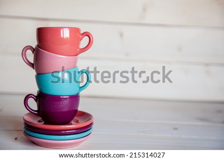 Bright dishes on table on a wooden background