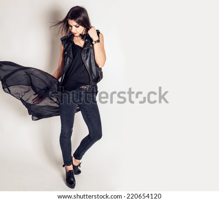 Young beautiful fashion model with professional makeup. Rock and punk style. Stylish dress and jeans. woman