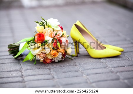 Beautiful wedding bouquet of roses and peonies on the pavement. Stylish and fashionable shoes bride yellow. Lemon yellow wedding. belt tiles. delicate flowers