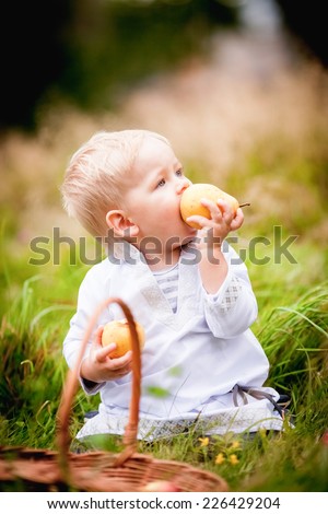 little boy with a basket and eats it with fruit