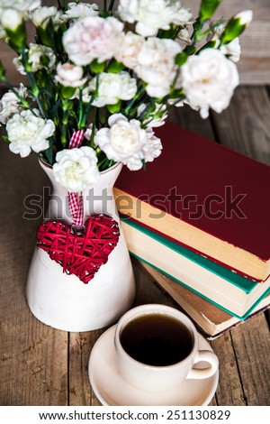 Cup of Coffee, books and flowers