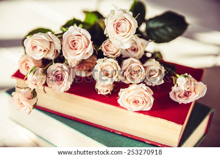 Beautiful bouquet of peach roses in vintage vase on a black background. Flowers