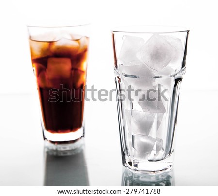 soft drinks. Cola glass with ice cubes over white