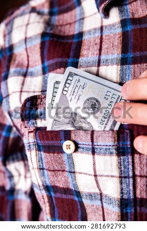 hundred american dollars in the pocket of shirt