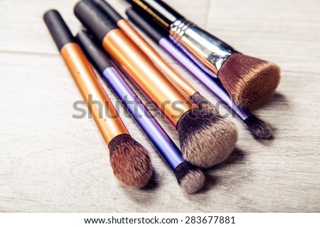 collection of make-up brushes over white