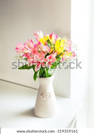 Alstroemeria flowers in vase on table