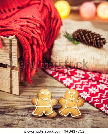 Christmas set. Warm blanket, sweater, socks, garland and a bump on the wooden background. cookies,Gingerbread Man