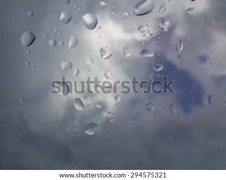 Rain drops after the rain with cloudy sky