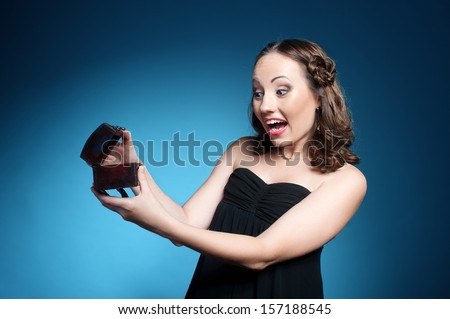 Portrait of beautiful young woman expressing surprise emotion while opening a box