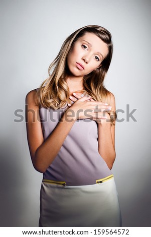 Portrait of beautiful teenage girl expressing sad emotion