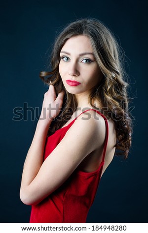 Portrait of fashion model beautiful young woman in red dress with evening make-up
