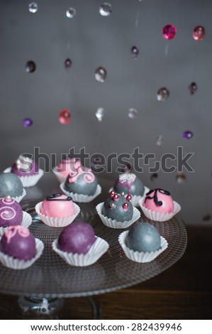 Variety of fruits (strawberry, banana, grape, pineapple) covered with a color chocolate and nuts, decoration of birthday or wedding party table