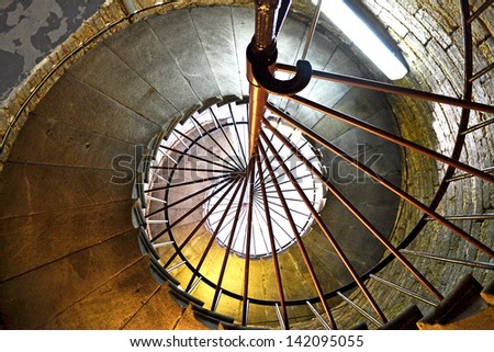 A spiral staircase in old tower going up