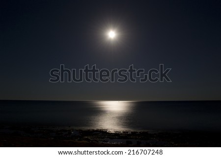 Moonlit path on the sea, night landscape.