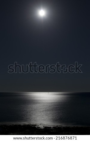 Moonlit path on the sea, night seascape.