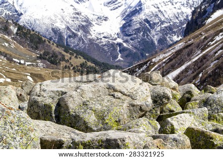 large stone against a blurred background of mountains, imitation canvas for drawing