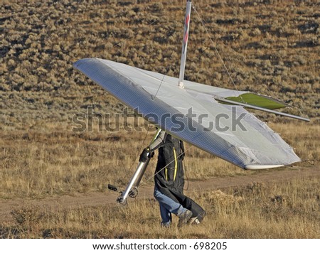 Walking Hang Glider back to take off point