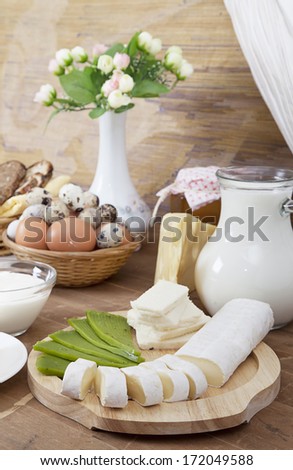 Colorful still life with gourmet cheese, milk and eggs